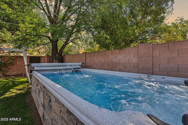 view of pool featuring a fenced backyard and a hot tub