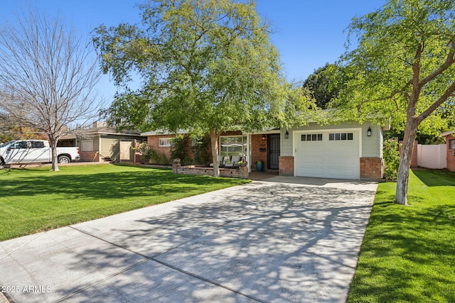 ranch-style home featuring driveway, fence, a front yard, a garage, and brick siding