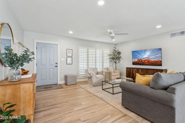 living room featuring visible vents, baseboards, ceiling fan, recessed lighting, and wood finished floors