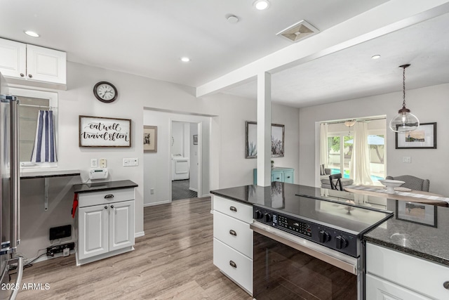 3420 N Kachina Ln, Scottsdale, AZ 85251 - kitchen with electric range, white cabinetry, washer / clothes dryer, light wood-style floors, and decorative light fixtures