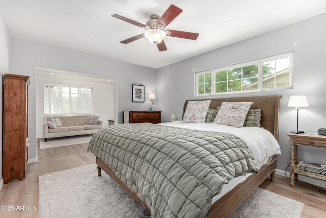 3420 N Kachina Ln, Scottsdale, AZ 85251 - bedroom with light wood-style flooring, baseboards, and a ceiling fan