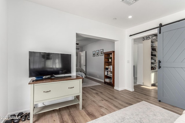 3420 N Kachina Ln, Scottsdale, AZ 85251 - living area with wood finished floors, a barn door, baseboards, and recessed lighting