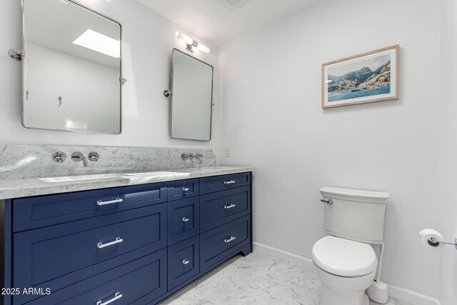 3420 N Kachina Ln, Scottsdale, AZ 85251 - bathroom with baseboards, double vanity, marble finish floors, and toilet
