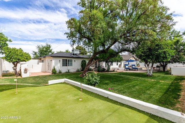 3420 N Kachina Ln, Scottsdale, AZ 85251 - back of property featuring a putting green, stucco siding, and a patio area