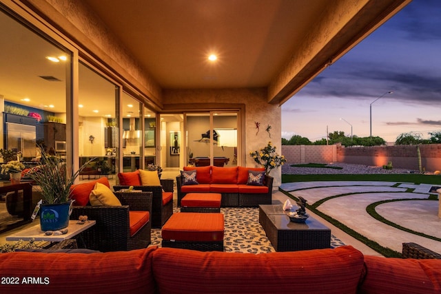 patio terrace at dusk featuring outdoor lounge area