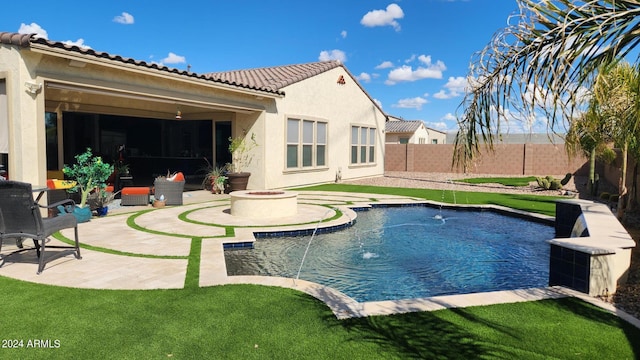 view of swimming pool featuring pool water feature, an outdoor fire pit, and a patio area