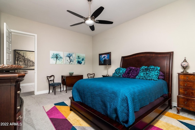 bedroom with ceiling fan and light colored carpet