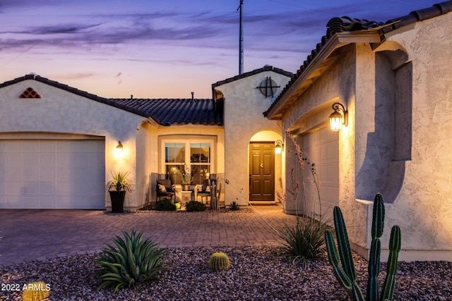 mediterranean / spanish home featuring a garage