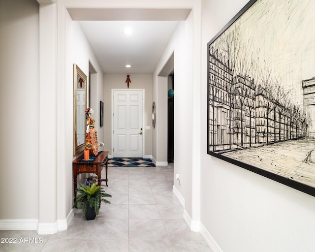 hall with light tile patterned floors