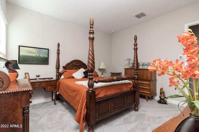 bedroom featuring light carpet