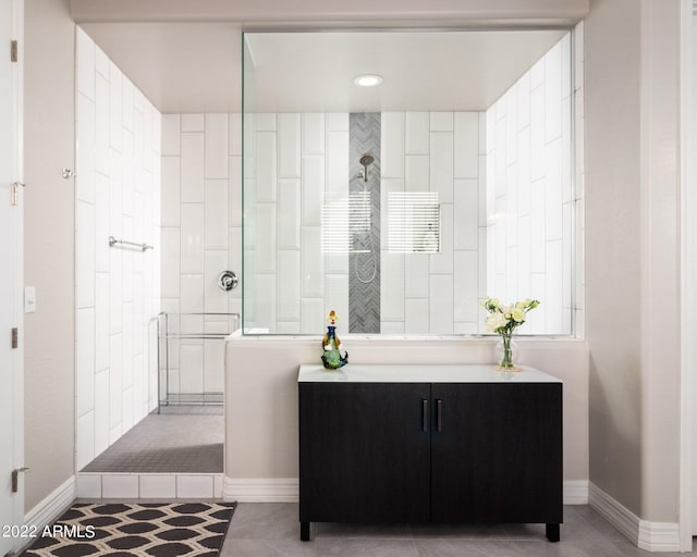 bathroom with tile patterned floors and a tile shower