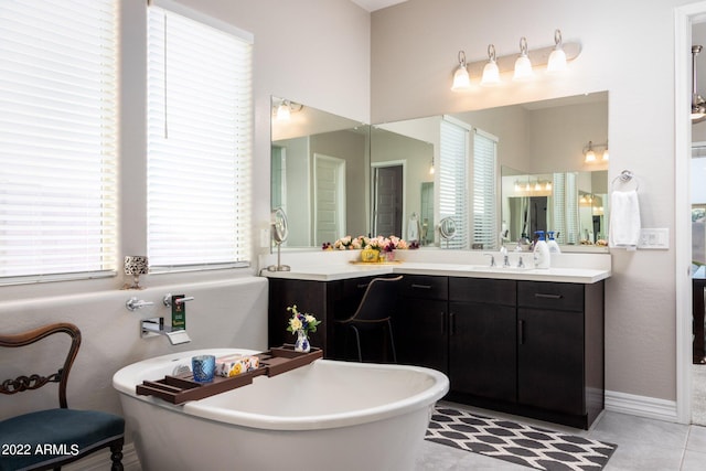 bathroom featuring vanity, a bathing tub, and tile patterned flooring