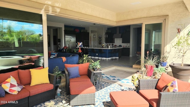 view of patio / terrace featuring a bar and an outdoor hangout area