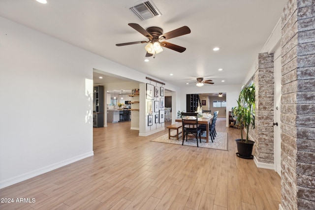 dining area featuring light hardwood / wood-style floors and ceiling fan