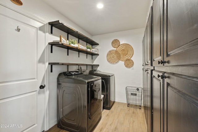 washroom featuring light wood-type flooring and washer and clothes dryer