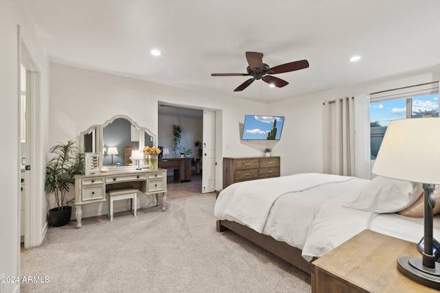 bedroom with ceiling fan and light colored carpet