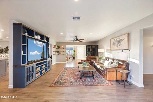 living room with light wood-type flooring and ceiling fan