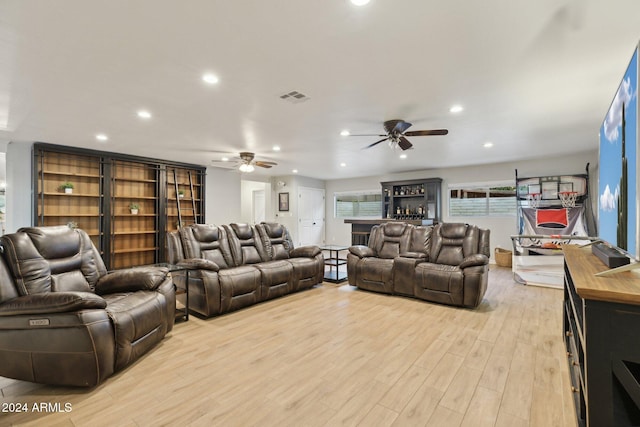 living room featuring ceiling fan and light hardwood / wood-style flooring