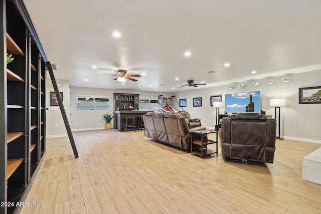 living room with light wood-type flooring and ceiling fan