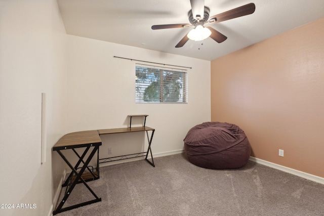 living area with carpet and ceiling fan