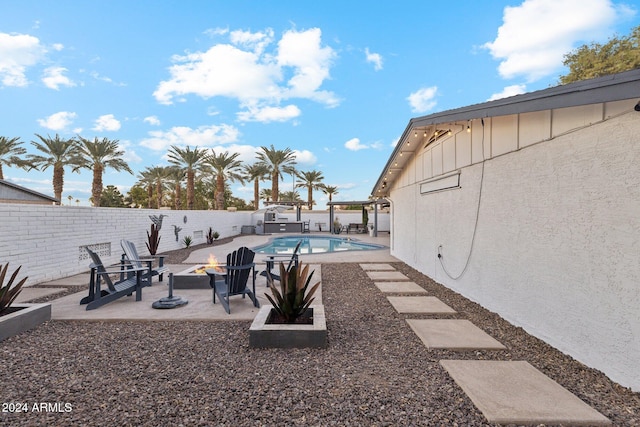 view of yard with a patio area, a fenced in pool, and a fire pit