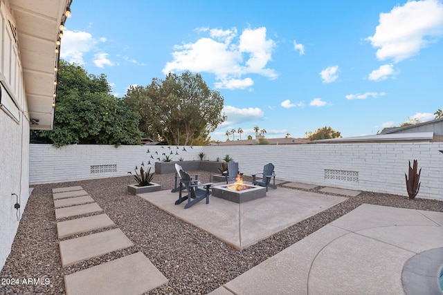 view of patio / terrace featuring an outdoor fire pit