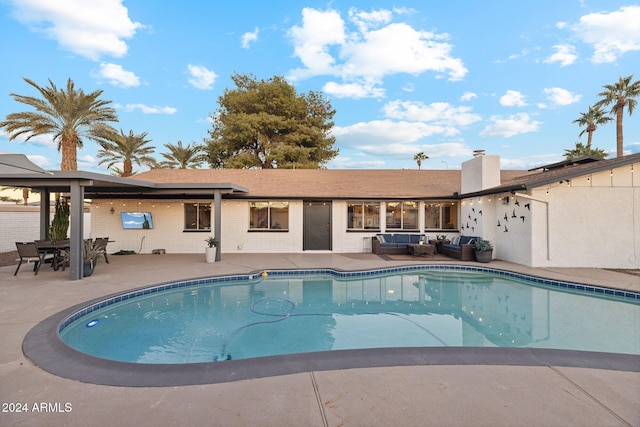 view of pool featuring an outdoor living space and a patio