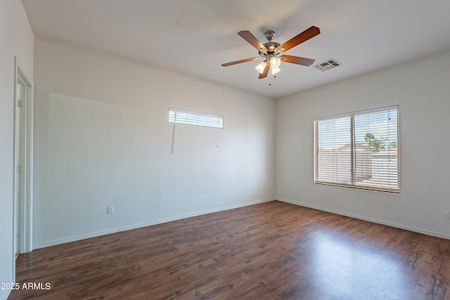 14244 N 132nd Ln, Surprise, AZ 85379 - unfurnished room featuring plenty of natural light, visible vents, ceiling fan, and dark wood-style floors