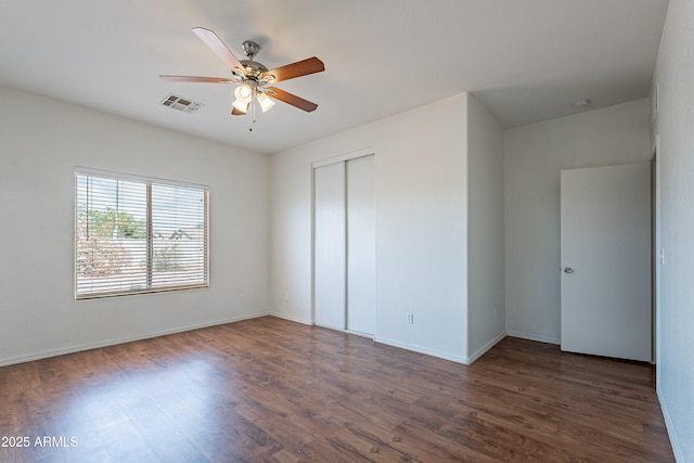 14244 N 132nd Ln, Surprise, AZ 85379 - unfurnished bedroom with a closet, baseboards, visible vents, and wood finished floors