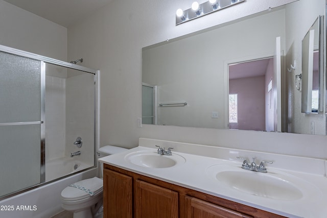 14244 N 132nd Ln, Surprise, AZ 85379 - bathroom featuring toilet, double vanity, a sink, and bath / shower combo with glass door