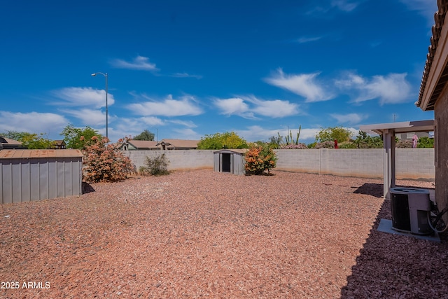 14244 N 132nd Ln, Surprise, AZ 85379 - view of yard featuring a fenced backyard, a storage shed, cooling unit, and an outbuilding