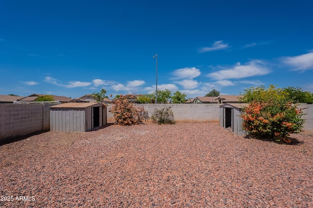 14244 N 132nd Ln, Surprise, AZ 85379 - view of yard with an outdoor structure, a shed, and a fenced backyard