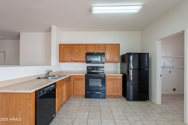 14244 N 132nd Ln, Surprise, AZ 85379 - kitchen with brown cabinetry, light tile patterned flooring, a sink, black appliances, and light countertops