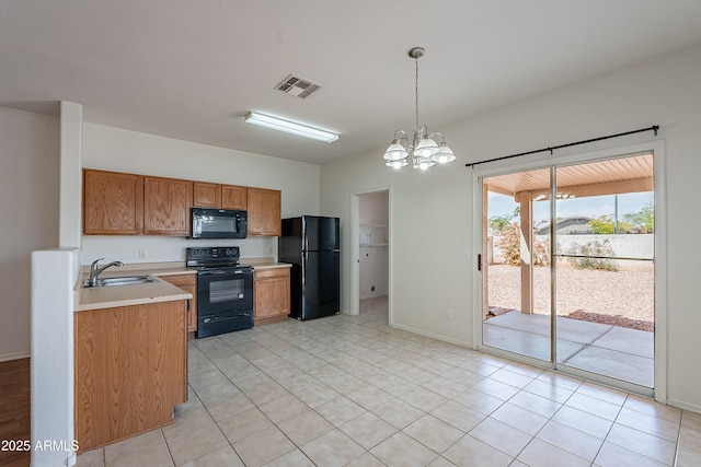 14244 N 132nd Ln, Surprise, AZ 85379 - kitchen featuring a sink, brown cabinets, black appliances, light countertops, and a notable chandelier