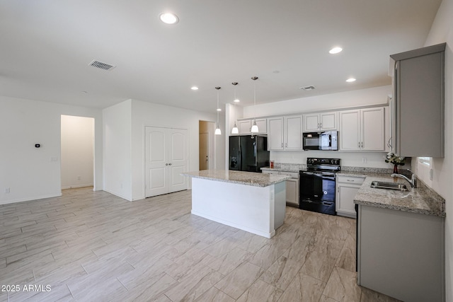 kitchen with sink, black appliances, decorative light fixtures, gray cabinets, and a kitchen island