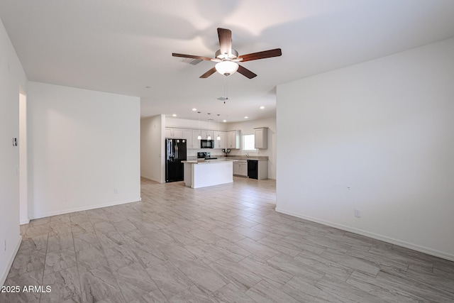 unfurnished living room with ceiling fan