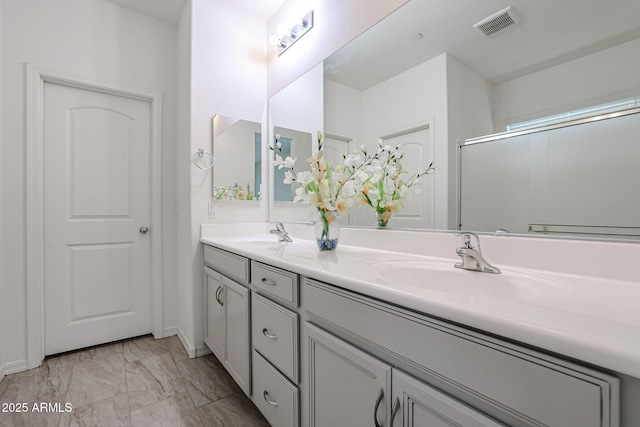 bathroom featuring vanity and an enclosed shower