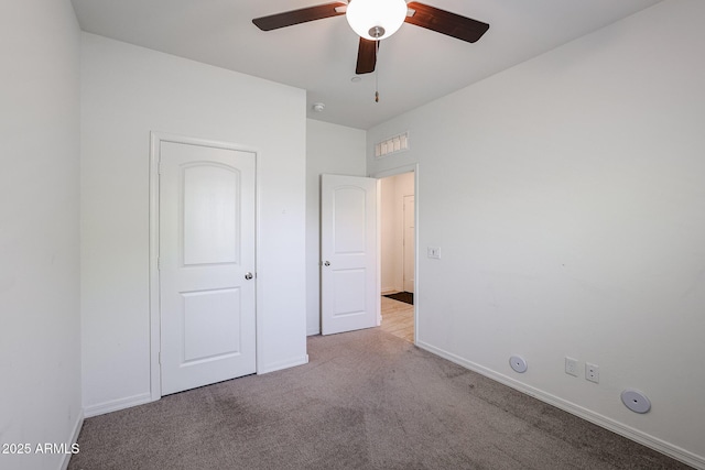 unfurnished bedroom featuring ceiling fan and light carpet