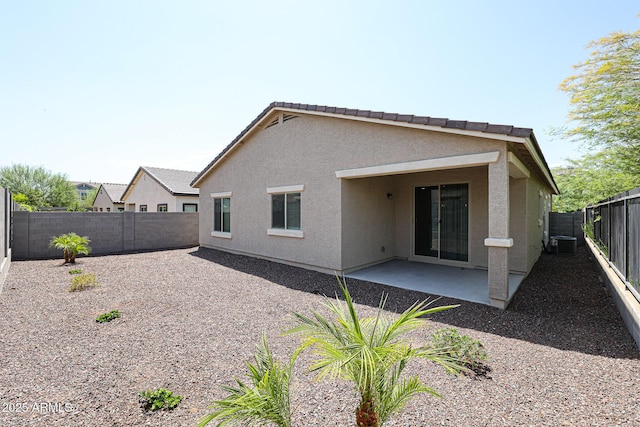 back of house featuring central air condition unit and a patio