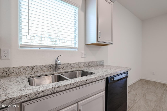 kitchen featuring light stone countertops, dishwasher, a healthy amount of sunlight, and sink