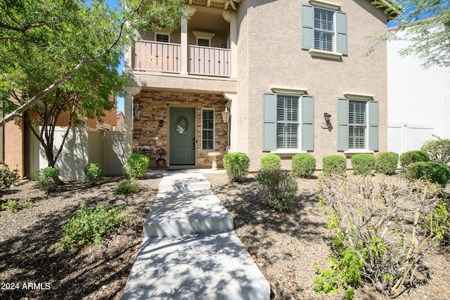 view of front of home featuring a balcony