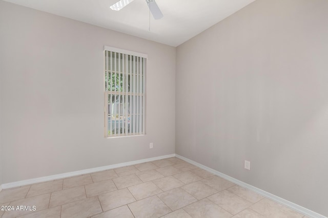 empty room with ceiling fan and baseboards