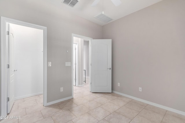 unfurnished bedroom featuring visible vents, baseboards, and light tile patterned floors