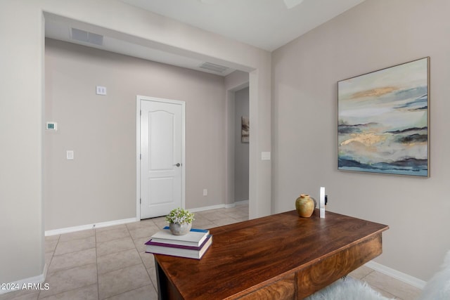 office space featuring light tile patterned flooring, visible vents, and baseboards