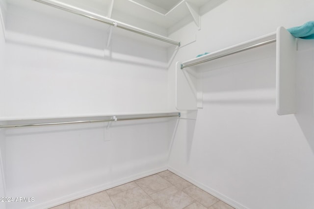 spacious closet with tile patterned floors