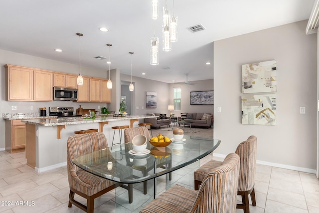 dining area with light tile patterned floors, baseboards, visible vents, and recessed lighting