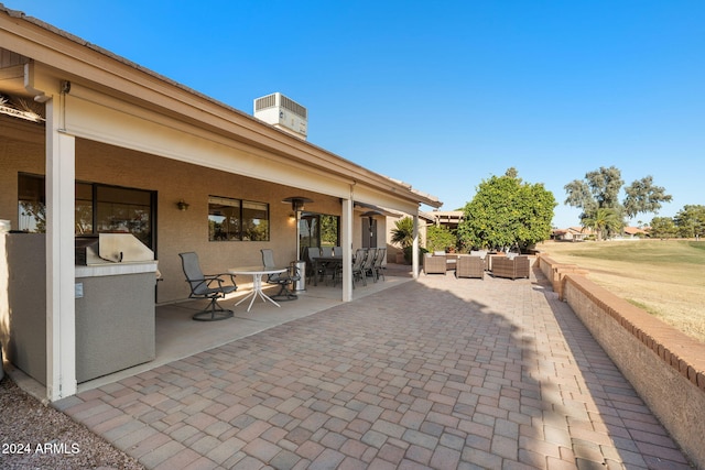 view of patio with an outdoor living space and ceiling fan