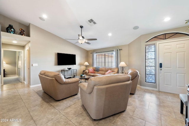 living room with ceiling fan, light tile patterned floors, and vaulted ceiling