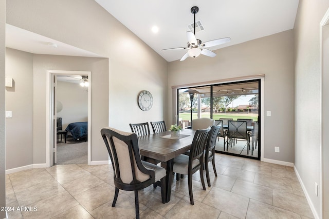 tiled dining room featuring ceiling fan and lofted ceiling