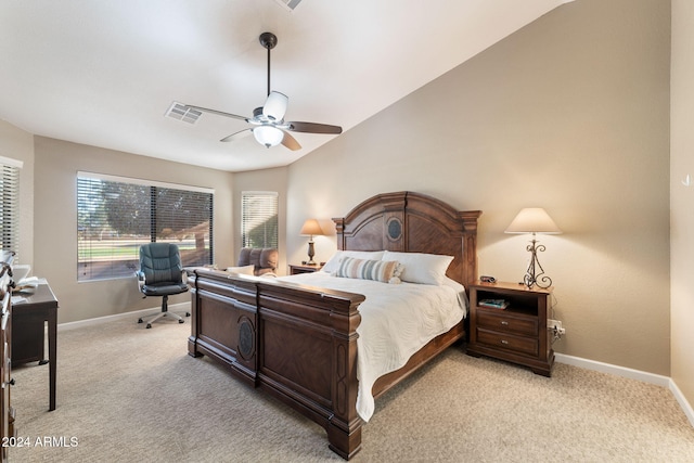 bedroom featuring ceiling fan, light colored carpet, and vaulted ceiling